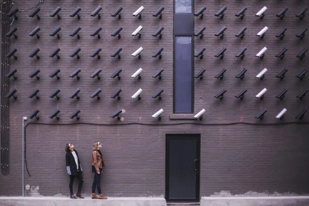 two-person-standing-under-lot-of-bullet-cctv-camera