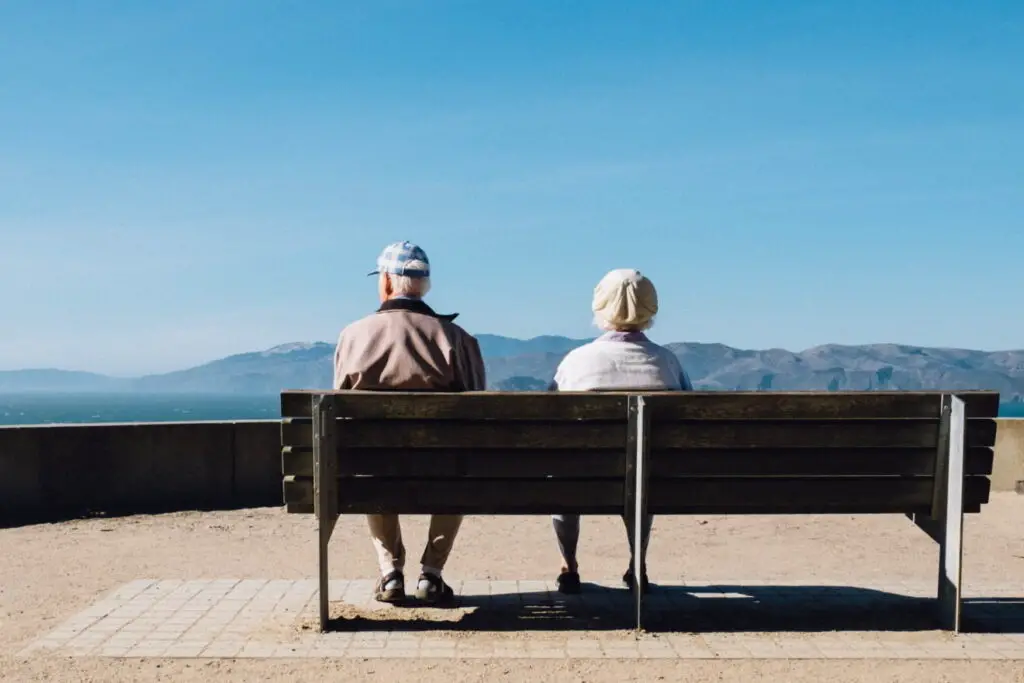 elderly couple sat down on a bench