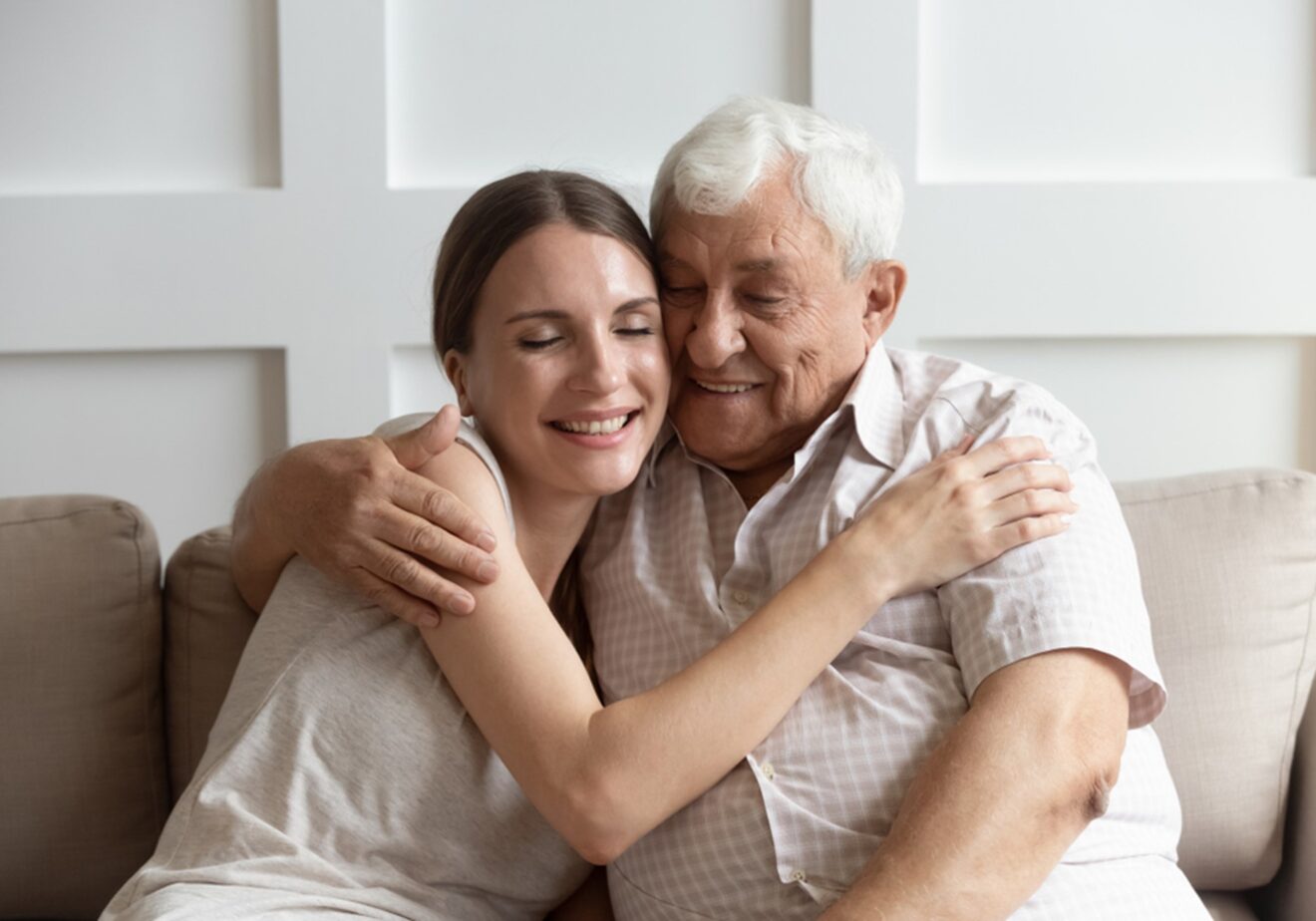 young woman hugging old man
